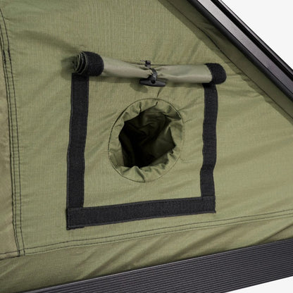 Round port in the Carbonlite tent wall with its rolled cover strapped above it