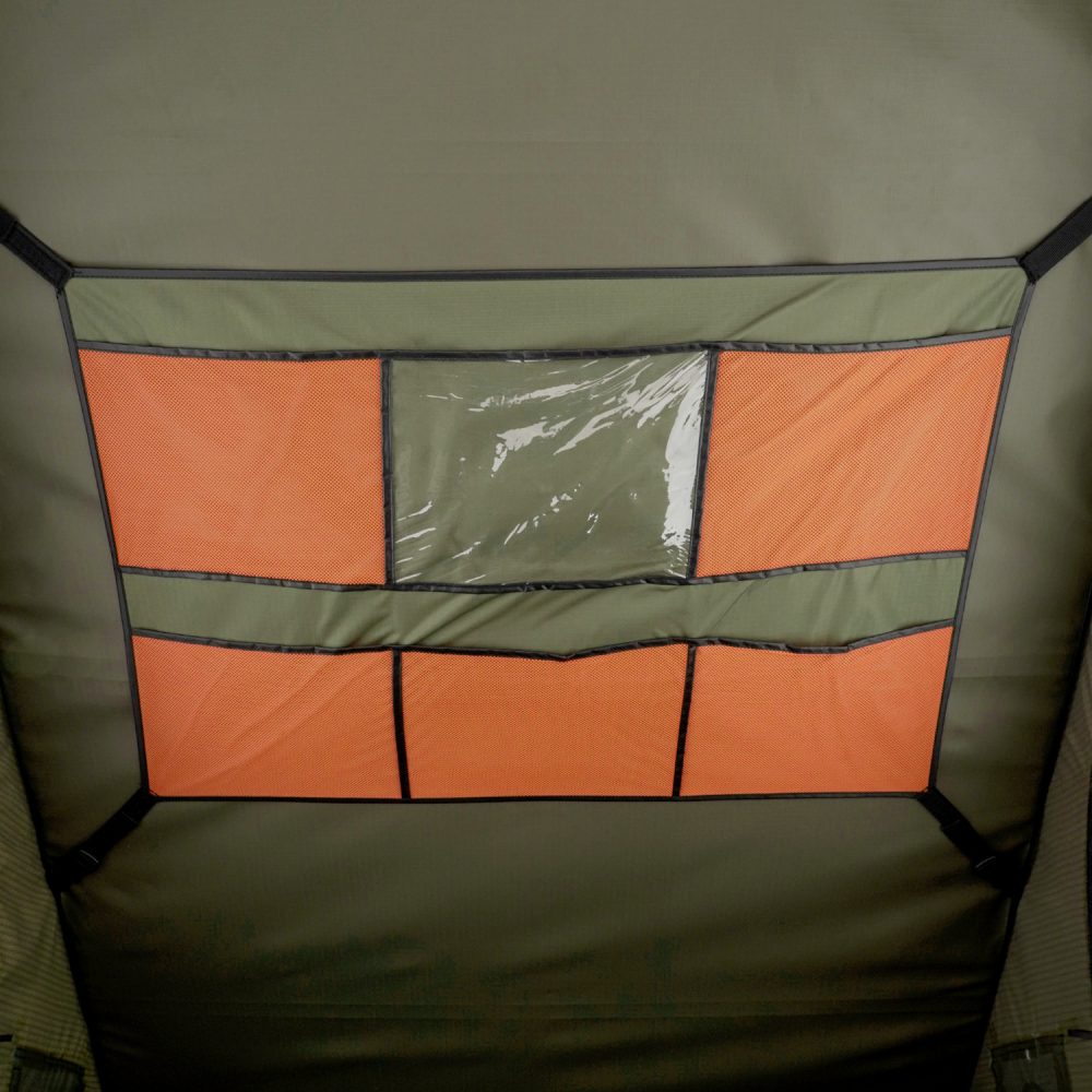 Interior storage panel in the Carbonlite with orange mesh pockets and a clear window pocket