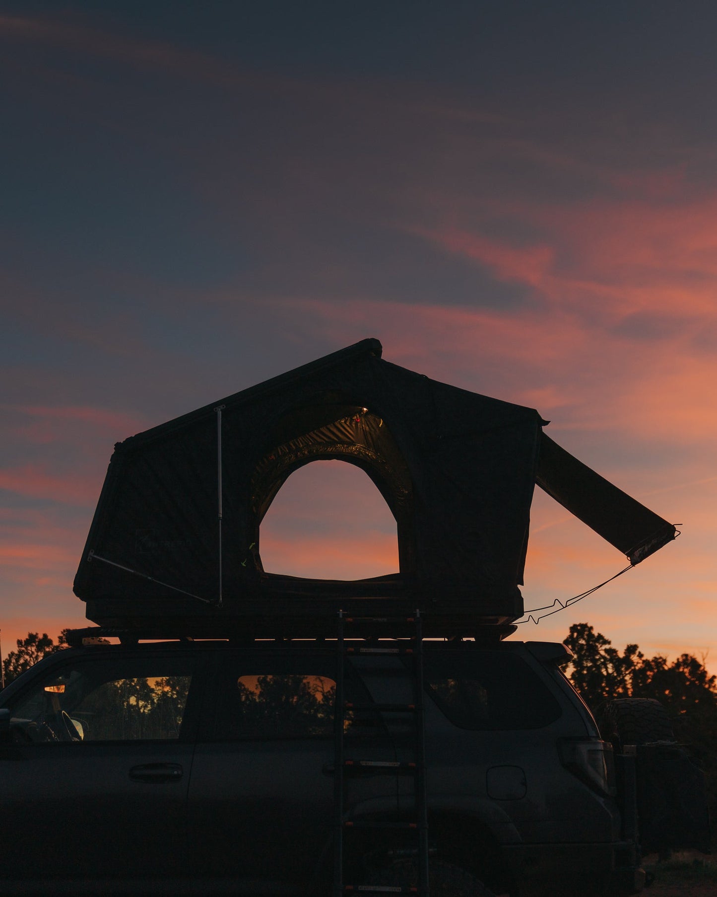 Intrepid Geo 3.0 Pro open on a 4Runner at sunset, awning extended and ladder down