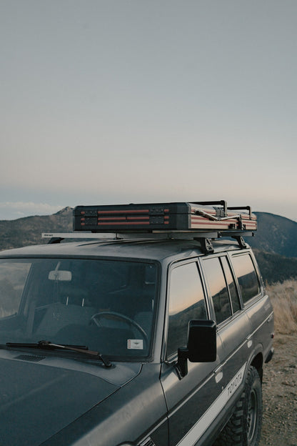 Intrepid Geo Solo closed on a Land Cruiser above a mountain valley