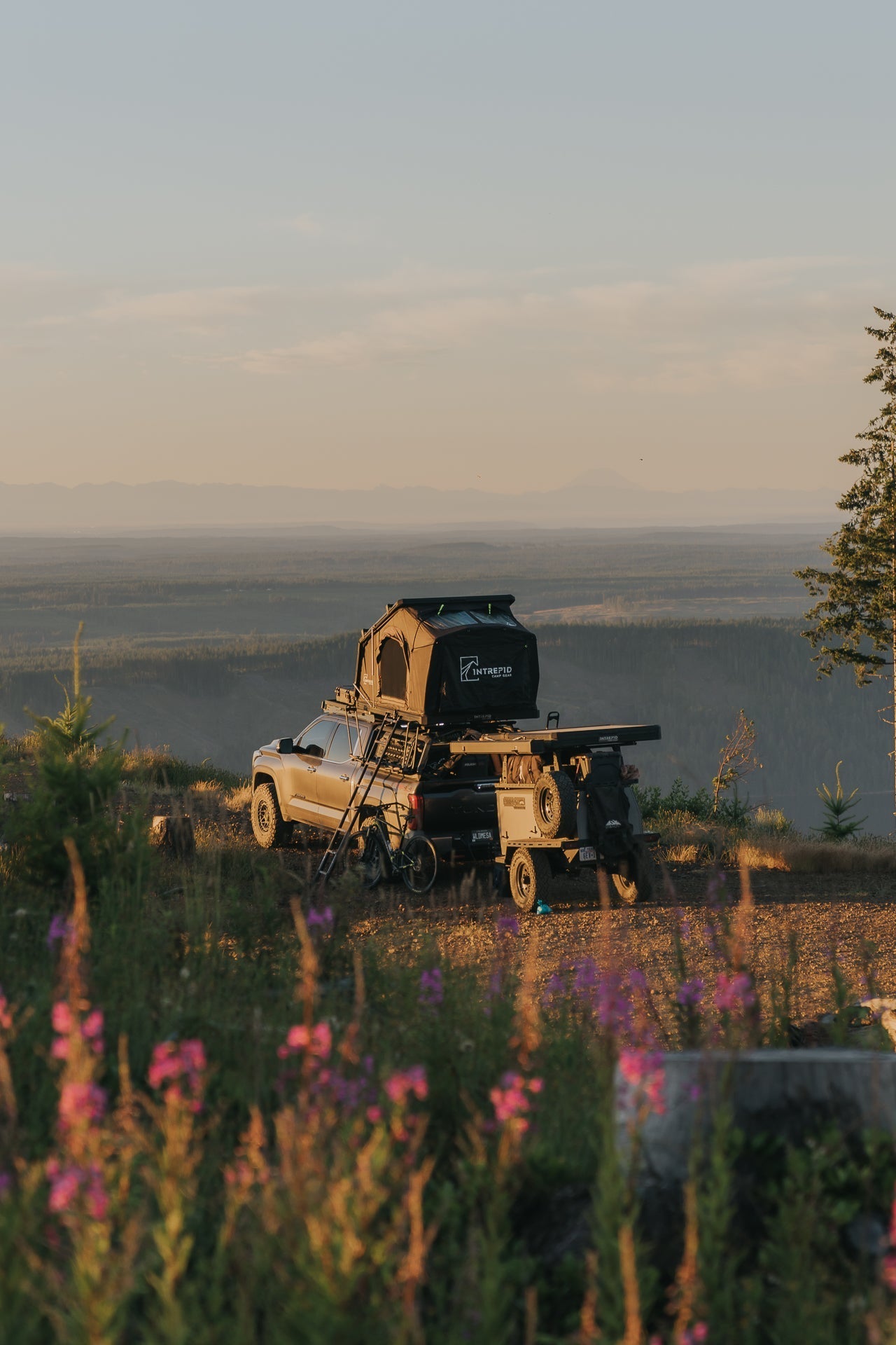 Intrepid Geo 3.0 open on a Tundra bed rack at golden hour, trailer behind