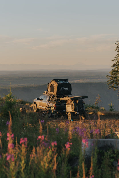 Intrepid Geo 3.0 open on a Tundra bed rack at golden hour, trailer behind