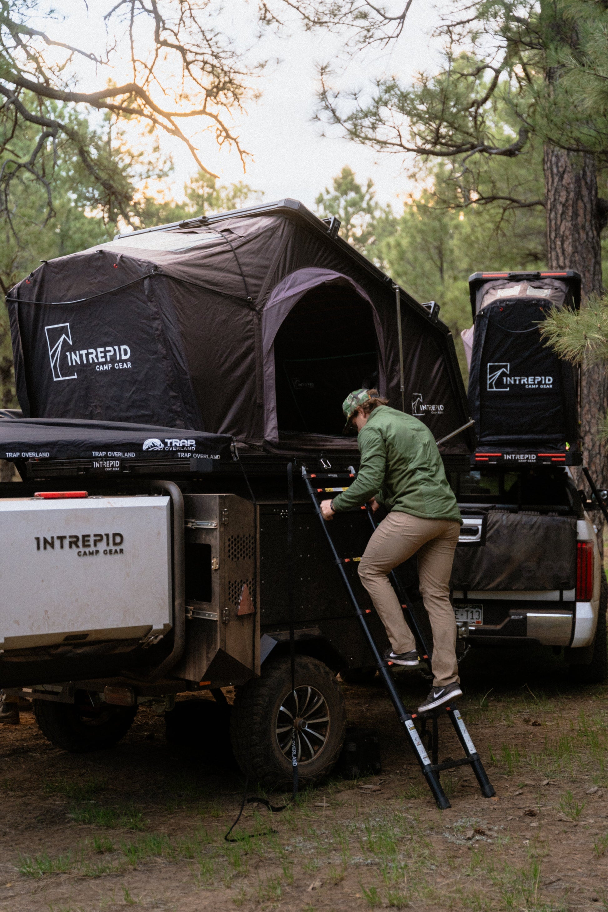 Climbing the ladder into an Intrepid Geo 3.0 Pro mounted on an Intrepid trailer