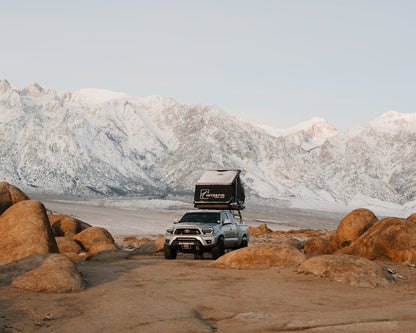 Intrepid Geo 2.5 open on a Tacoma below snow-covered mountains
