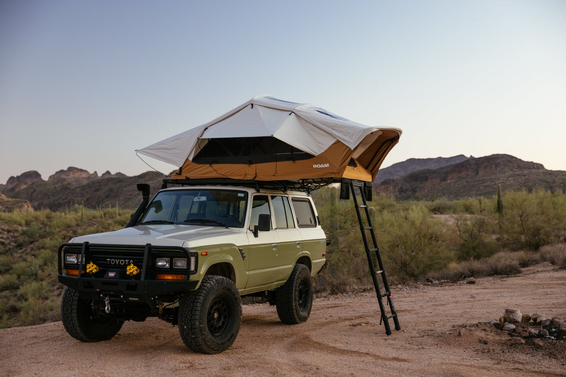 ROAM Vagabond XL 2.0 in Sand, open on a Land Cruiser with the ladder down