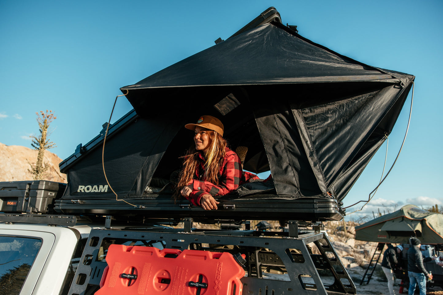 Sitting in the open ROAM Desperado at a desert camp