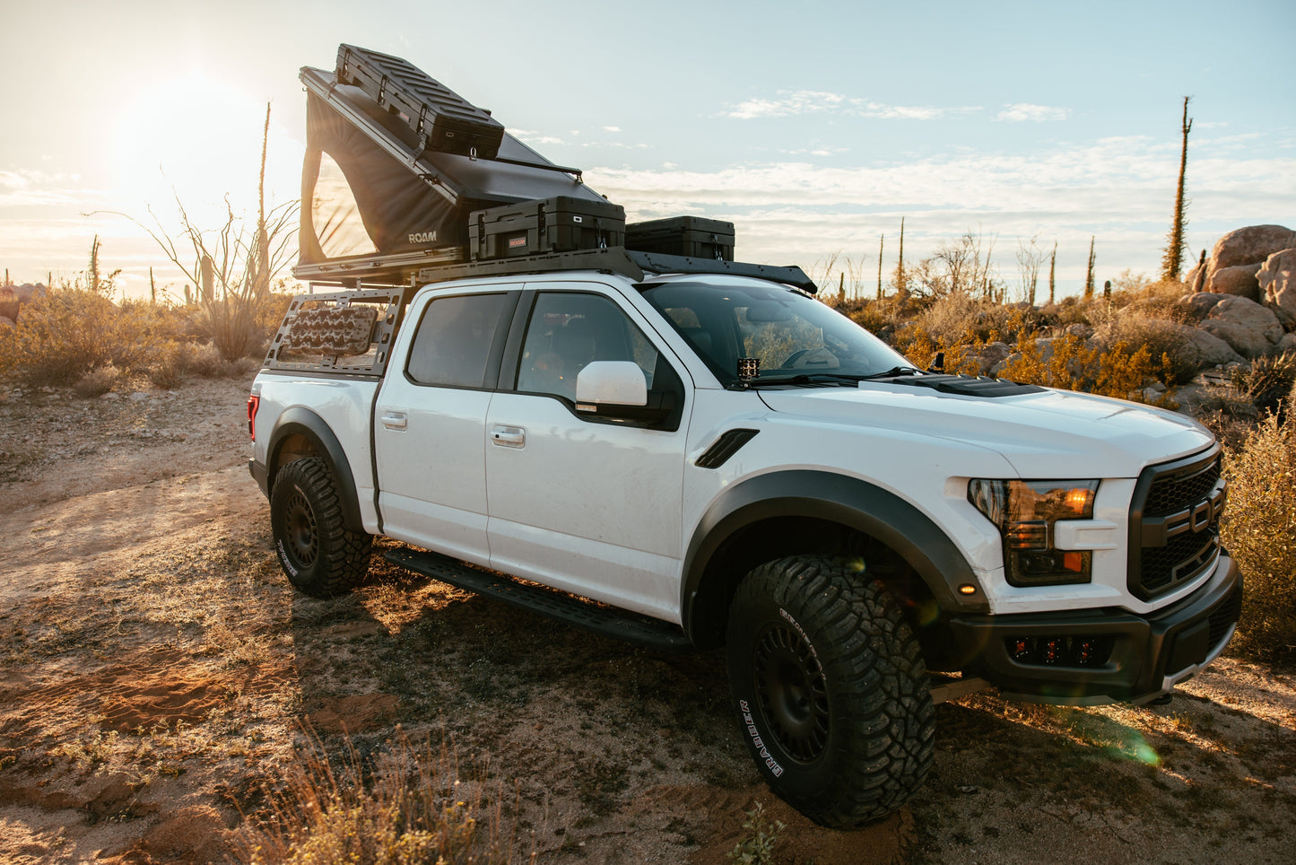 ROAM Desperado open on a Ford Raptor among saguaros at sunset
